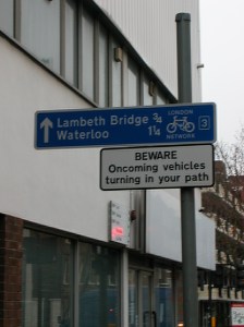 Follow the cycle route sign but the sign also says oncoming vehicles in your path.
