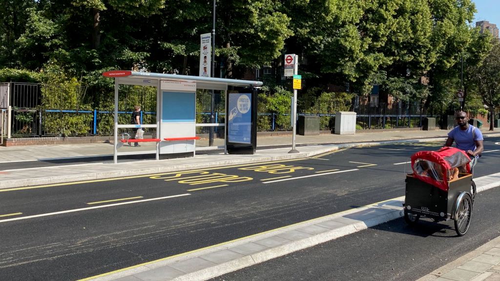 Man cycles on Baylis Road cycle way with cargo bike